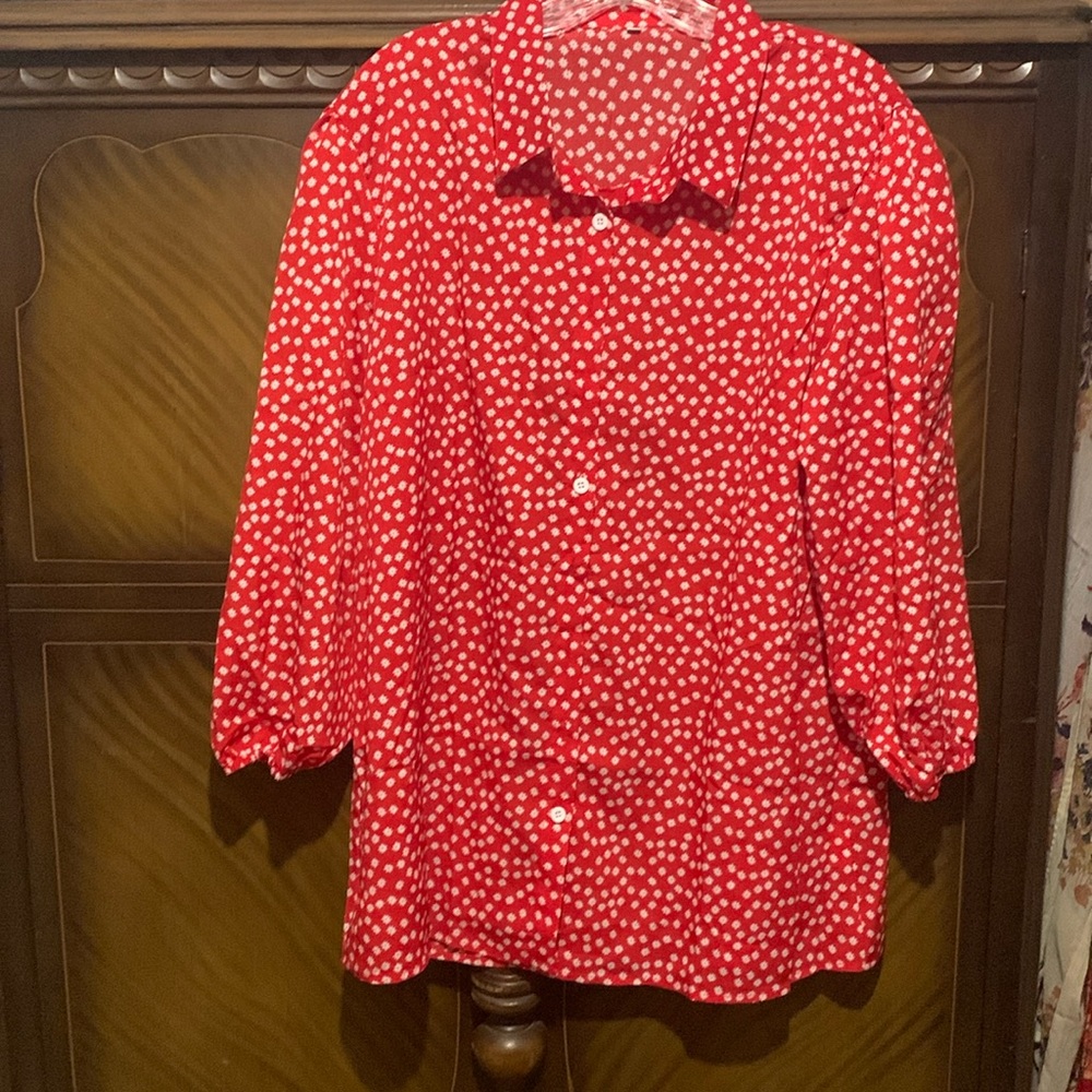 Ladies red blouse with 3/4 elastic at the bottom sleeves.